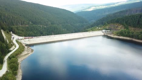 forward drone shot of a dam on the road to transalpina in romania