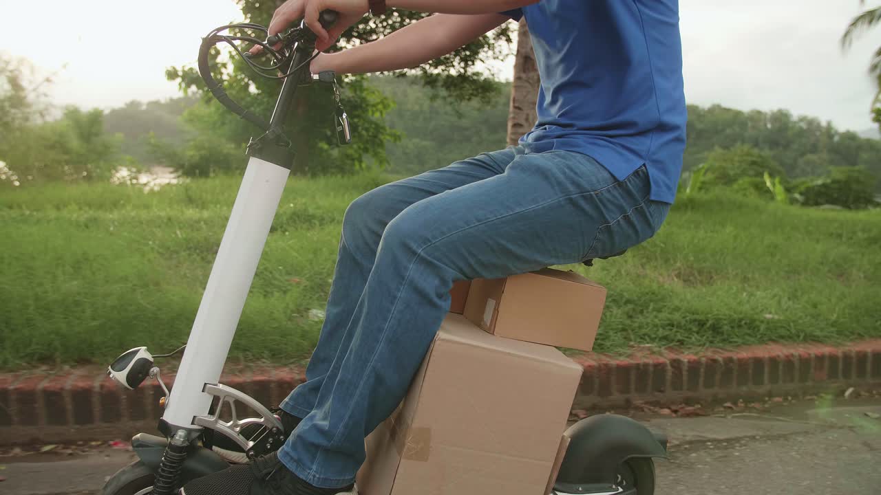 Delivery Asian Man Courier Rides A Electric Scooter On The Road To Deliver Orders And Packages For Customers