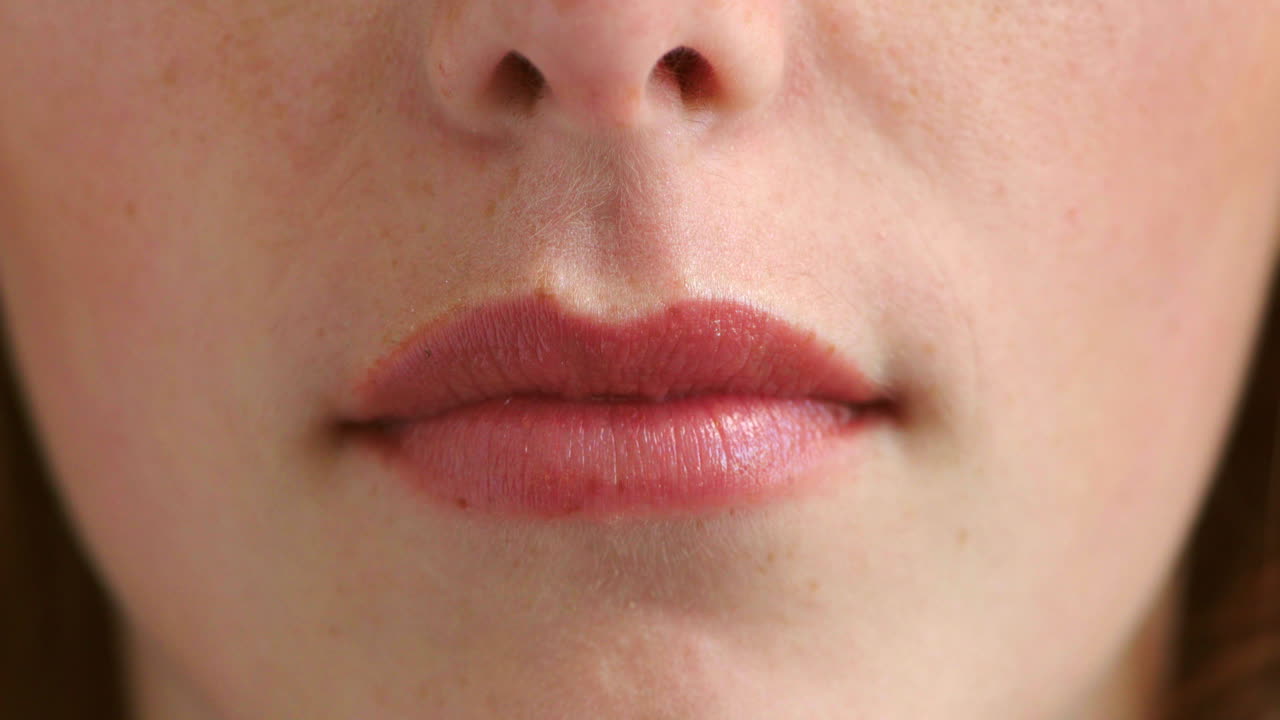 Closeup of woman's perfect lips with natural pink