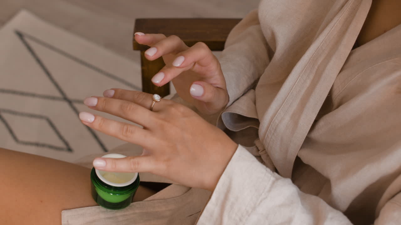 Woman applying cream to hands