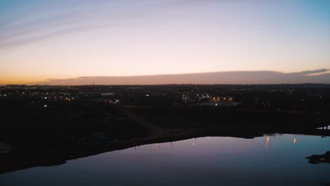 busy roads with a golden sunset in the distance. the river is so clam that makes beautiful reflections.