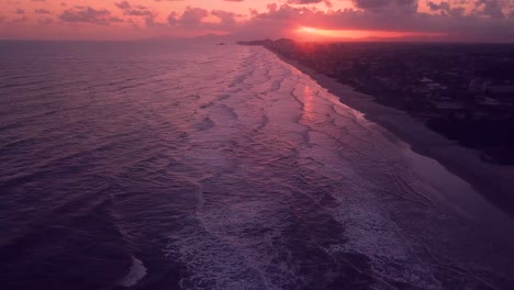 Tilting-aerial-shot-of-waves-in-the-beach-of-Itanhaem-in-Brazil