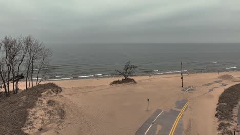 wind throwing sand along the streets of the coast