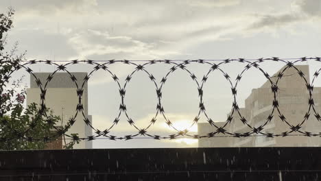 looped barbed wire property security wall fence in bauru city, brazil