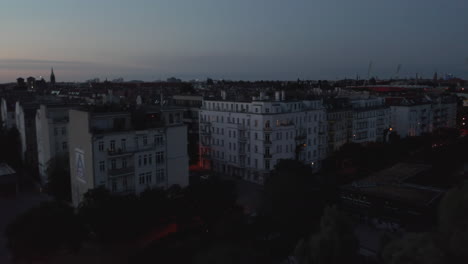 Low-flight-above-multistorey-residential-buildings.-Blocks-of-tenement-houses-in-urban-neighbourhood.-City-before-sunrise.-Berlin,-Germany