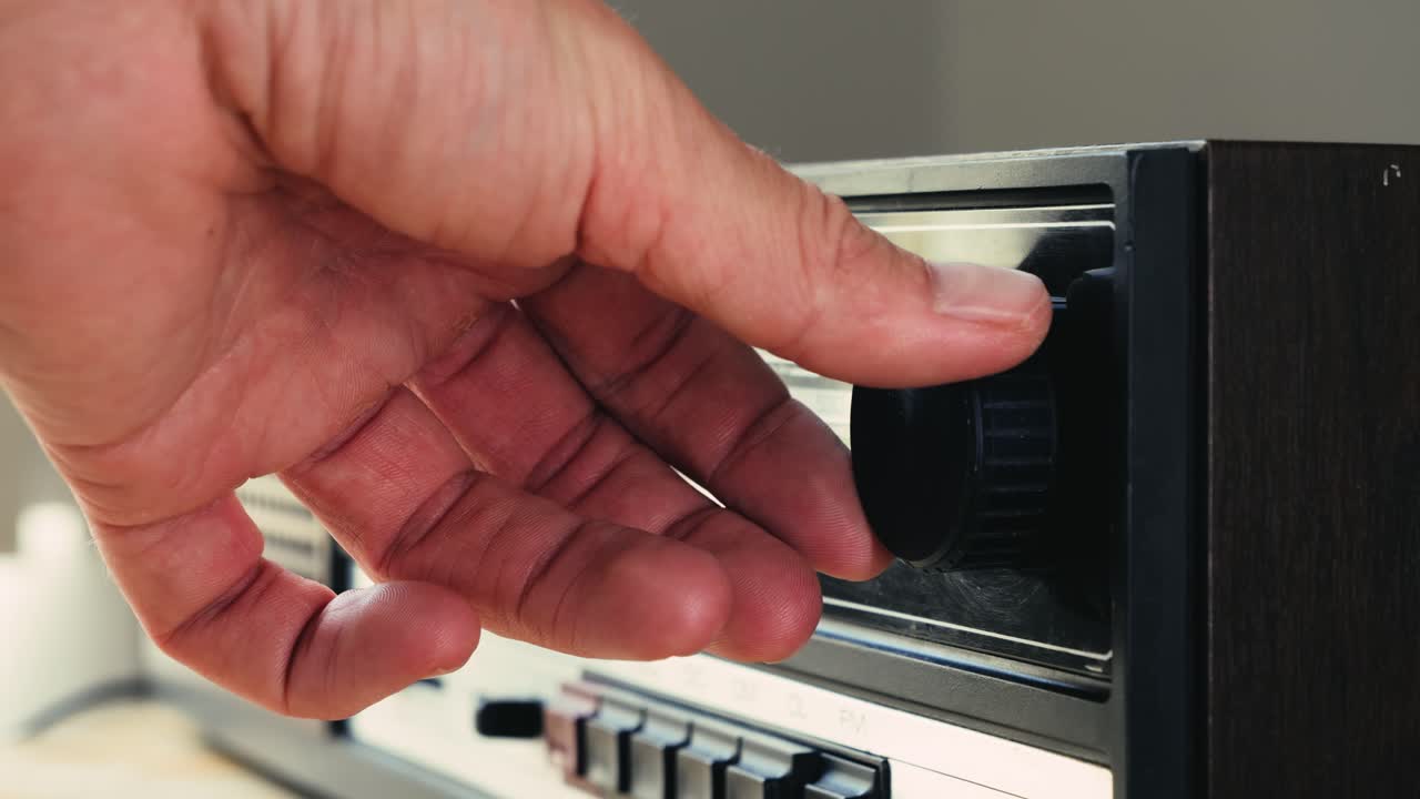 Person tuning a vintage radio