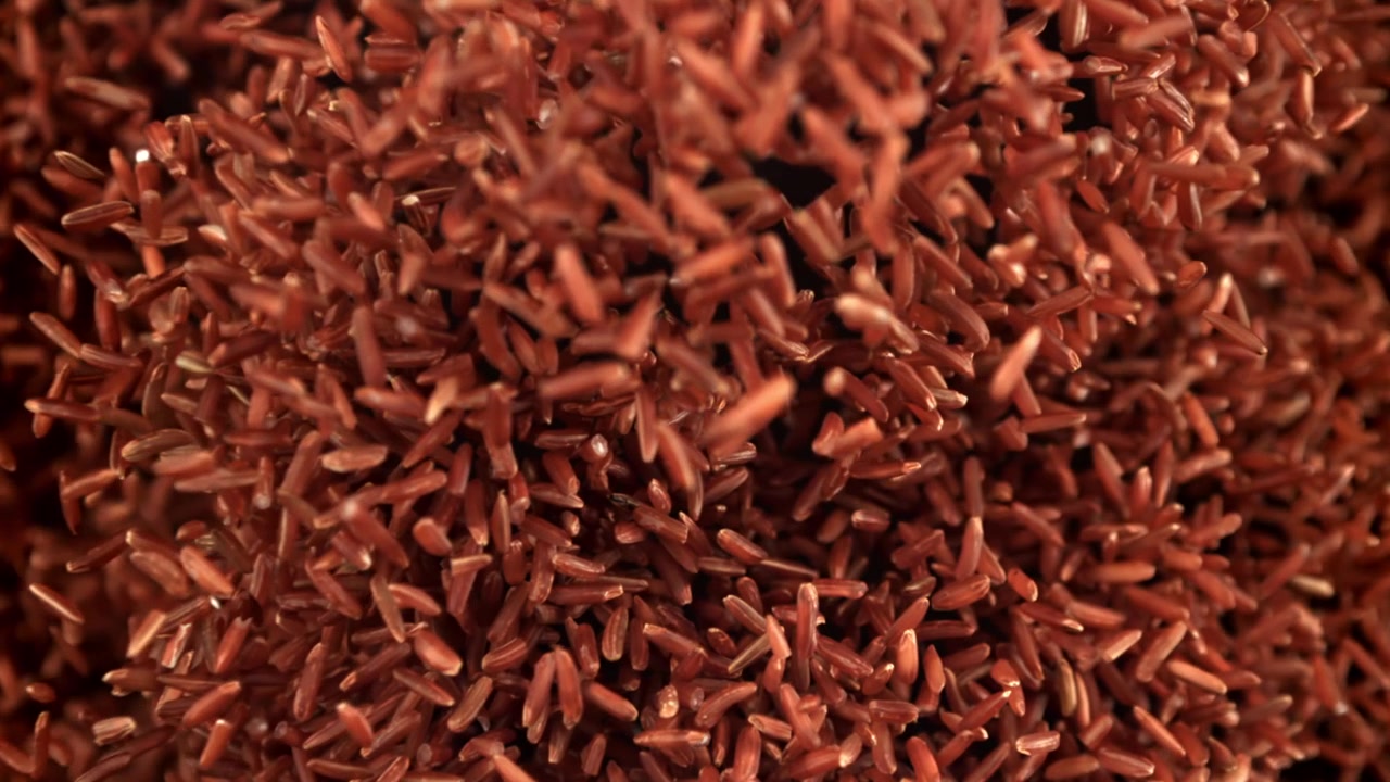 Close-up of Red Rice Grains Falling in Slow Motion