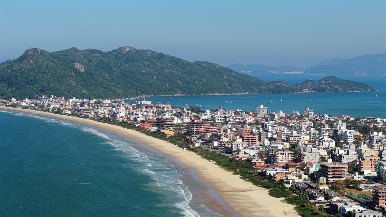 Aerial View of Mariscal and Canto Grande Beach, White Sand Coastline and Lush Green Mountains in Bombinhas, Santa Catarina, Brazil