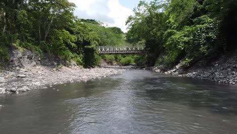 Flying-over-a-river-in-Utica,-Colombia