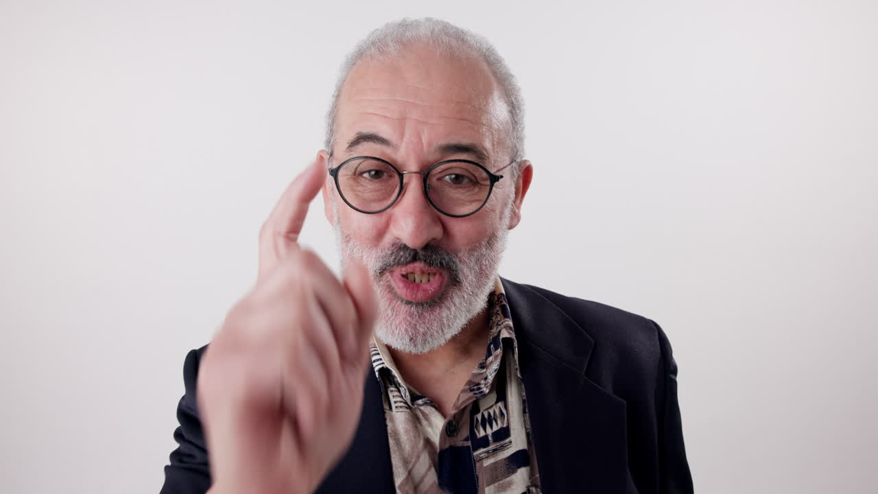 Portrait of a senior man in a suit pointing
