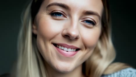 retrato de una mujer rubia sonriente con ojos azules