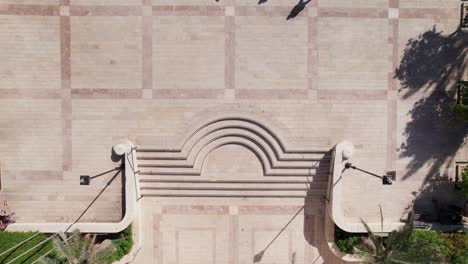 shadow of people walking in suzanne dellal centre - top down view