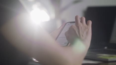 closeup shot of woman's hand typing an email message on her phone