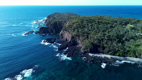 Drone-aerial-landscape-Burrewarra-Point-headland-cliff-bushland-trees-walking-track-coastline-rocky-Guerilla-Bay-South-Coast-Tourism-Batemans-Bay-NSW-Australia-4K