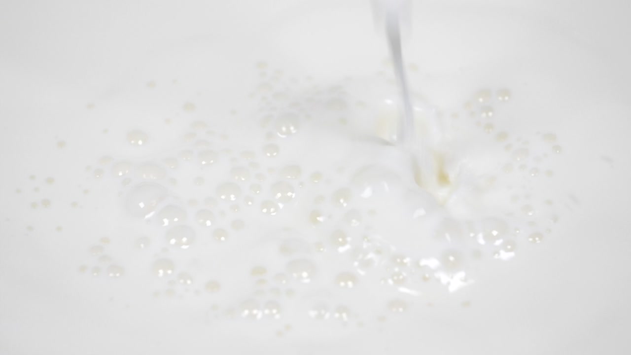 Pouring fresh milk in super slow motion 4k
