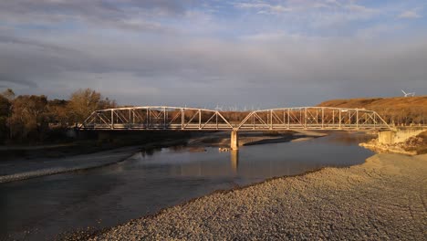 ascending aerial footage of an old truss bridge in rural alberta, canada