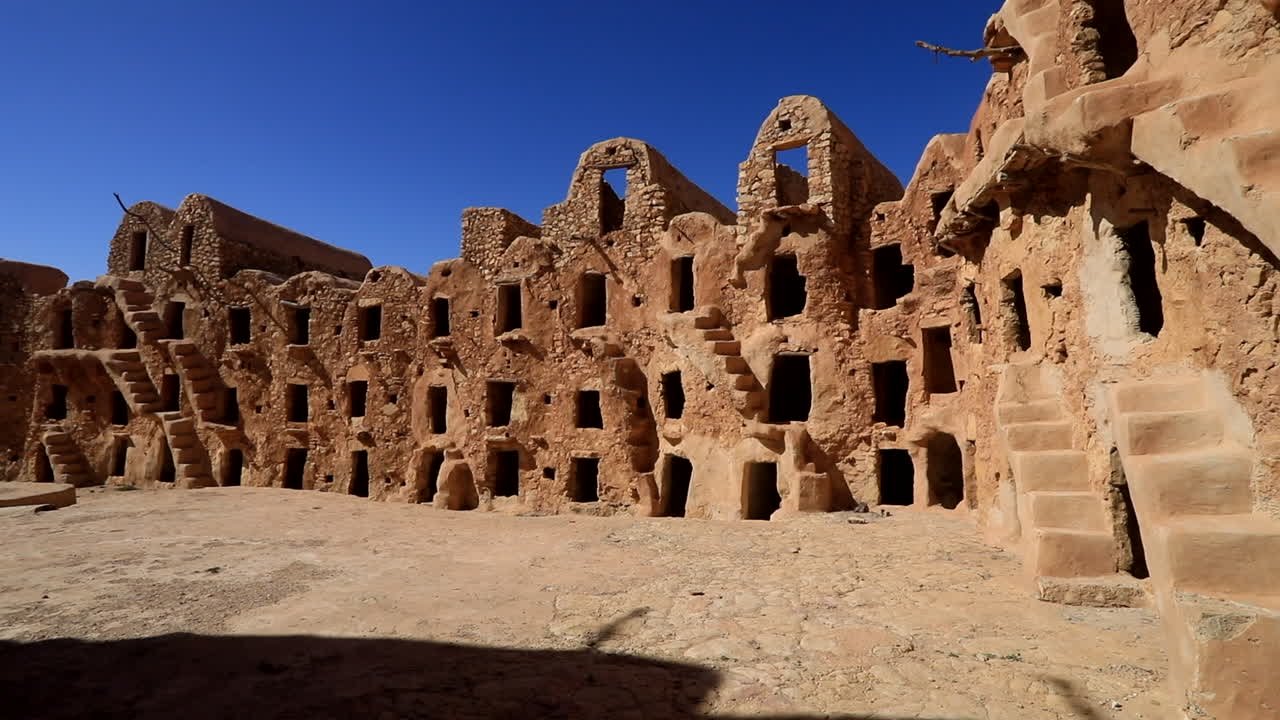 Ancient ksar in Tunisia with unique architecture and stone buildings under a clear blue sky