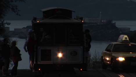 Mediumshot-of-a-San-Francisco-cable-car-with-Alcatraz-Island-in-the-distance