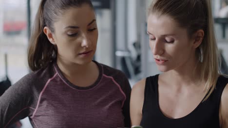 Tilt-up-video-of-personal-trainer-guiding-woman-at-gym