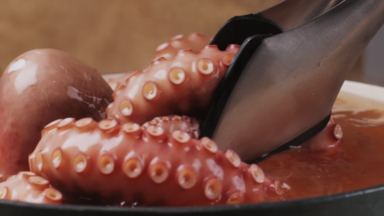 Octopus cooking, chef Boiling fresh octopus on restaurant kitchen, healthy food, seafood cafe in spain, traditional asian japanese spanish and mediterranean dish.