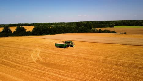 aerial view of agricultural machine working in a farmland