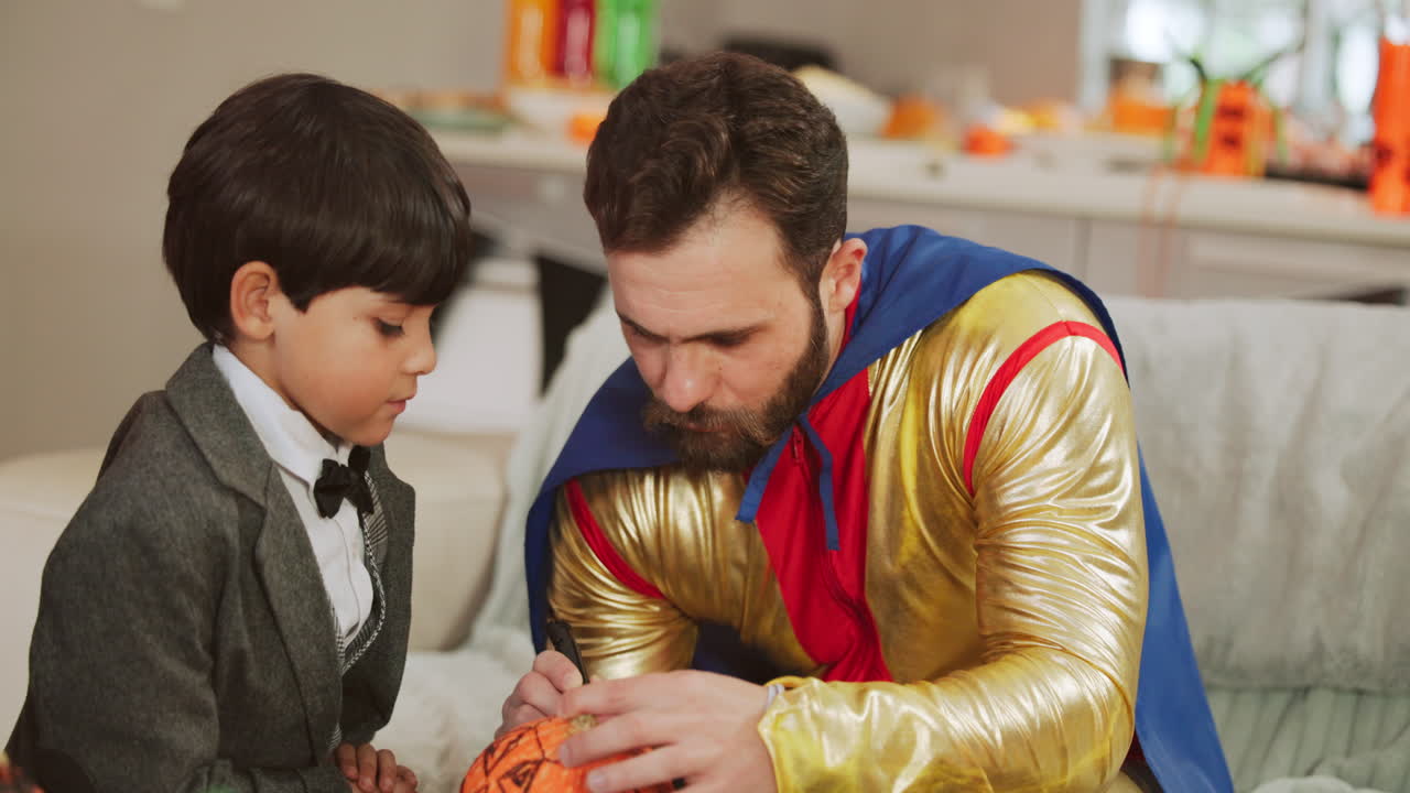 Father and Son Carving Pumpkins in Costume for Halloween