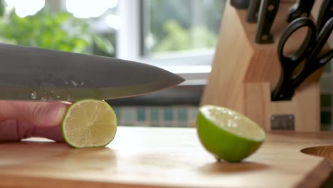 slow motion shot of a lime being sliced