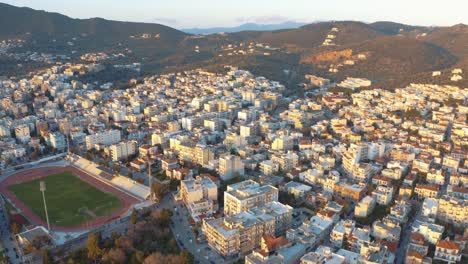 aerial drone flight descending to mitilini,city center houses turning to hills and mountains, mytilene lesvos, greece