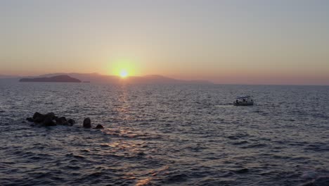 Aerial---Fishing-boat-in-Chania-Greece-at-sunset