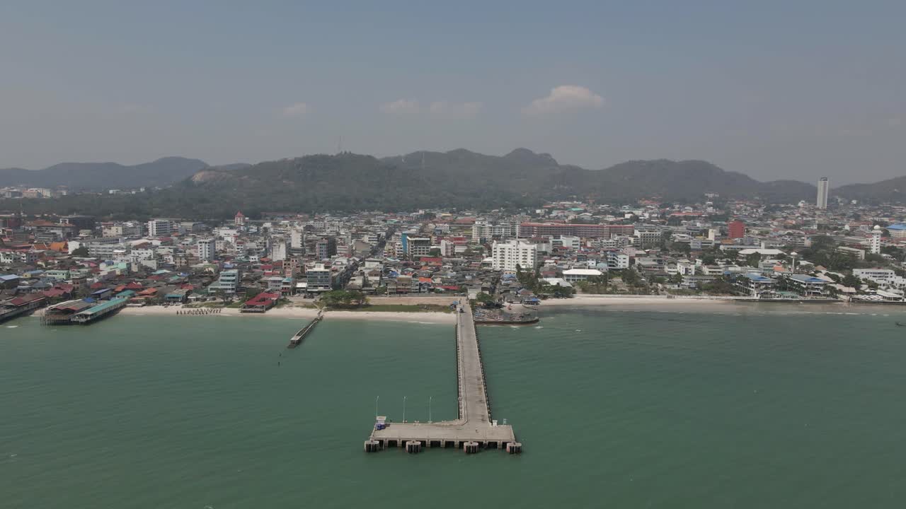 Hua Hin city waterfront aerial pulls out from fishing pier in Thailand