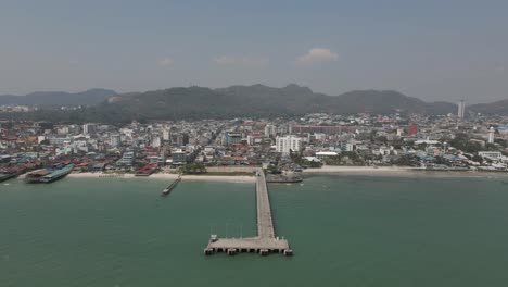 hua hin city waterfront aerial pulls out from fishing pier in thailand