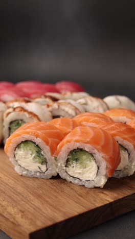 assortment of sushi rolls on wooden board