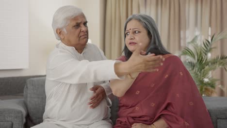 angry indian old couple fighting for tv remote