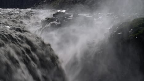 slow motion close up of splashing and spraying dettifoss waterfall during sunlight - famous waterfall in iceland