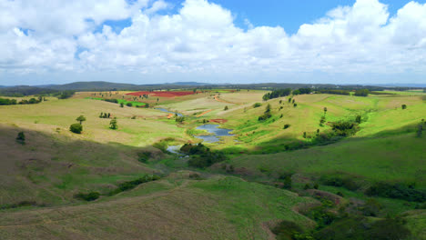 nature landscape with green fields and creeks in atherton tablelands, queensland, australia - aerial drone shot