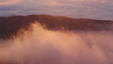 low clouds at portugal countryside monsanto village during magical sunrise, aerial