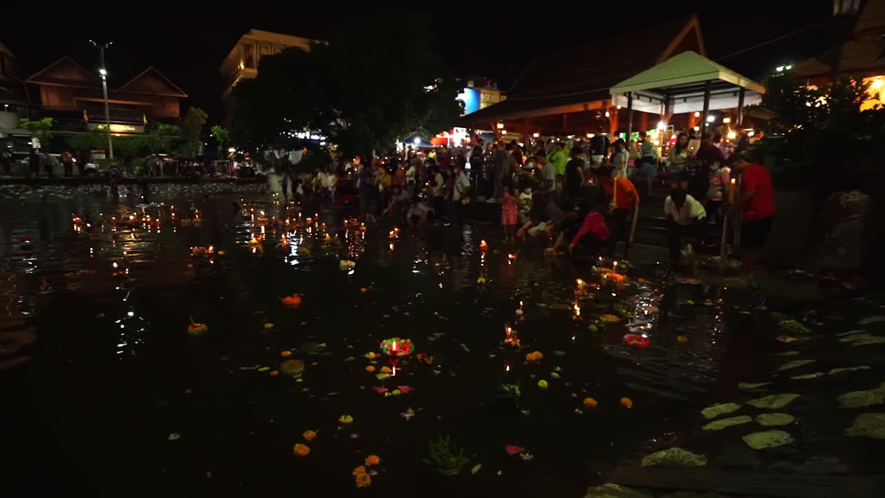 Particpents of the Loy Krathong Festival launch beautifully decorated baskets, called krathongs, into a lake at night in Thailand to pay respect to the goddess of water.