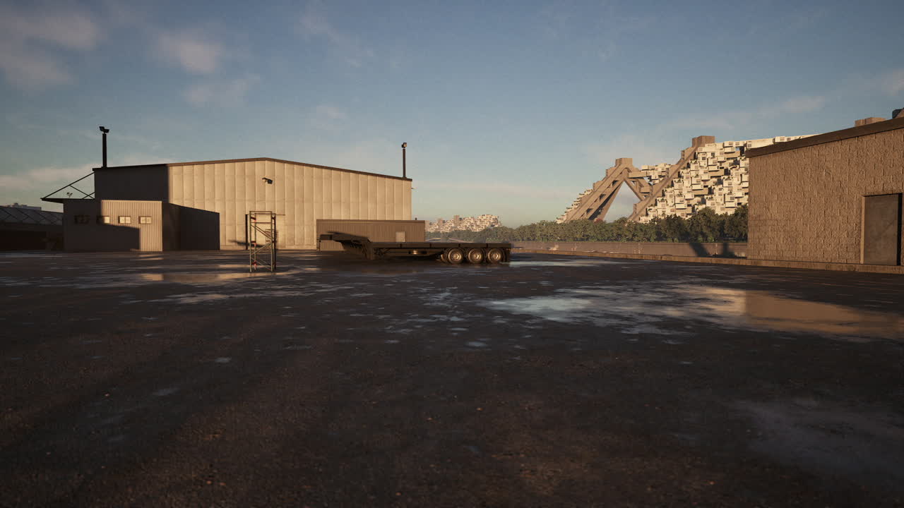 Industrial warehouse with trailer at a construction site under clear sky