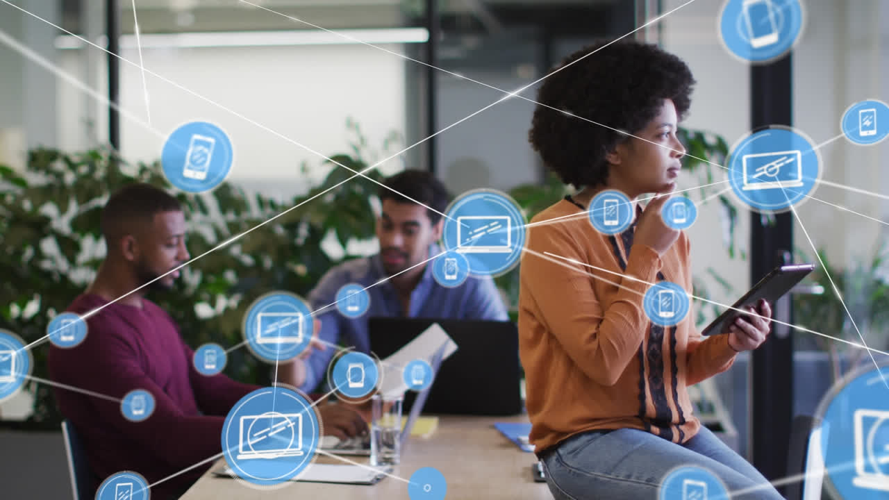 Animation of media icons over diverse business people using tablet and thinking