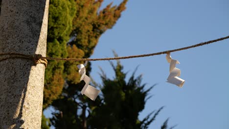 Close-up-detail-at-Japanese-shrine-with-paper-softly-flowing-in-wind