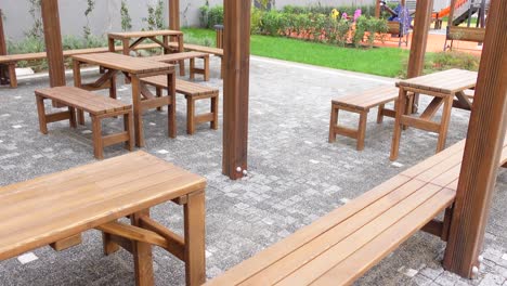 wooden picnic tables and benches in an outdoor area