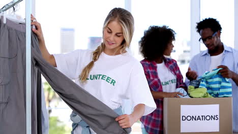 pretty volunteer looking at clothes