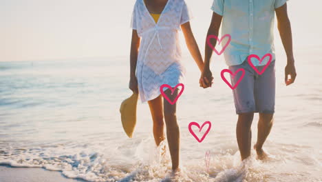 animation of hearts moving over diverse couple in love holding hands on beach in summer