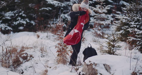 tourist drinking coffee in woods in winter