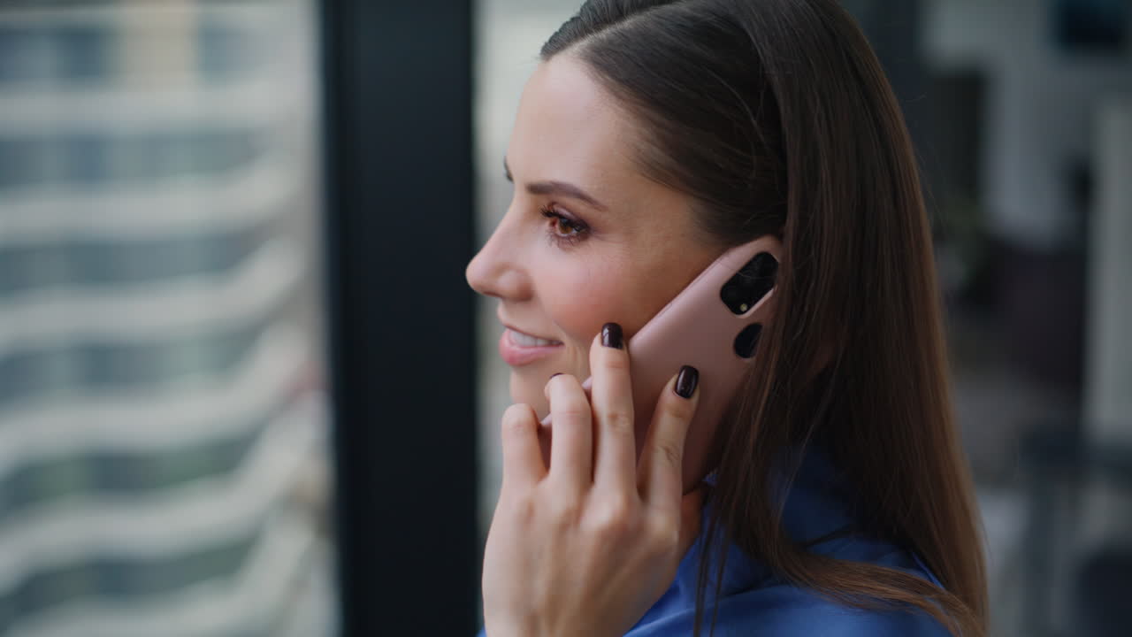Closeup manager talking smartphone looking office window. Businesswoman calling