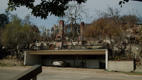aftermath of a fire: damaged house and car