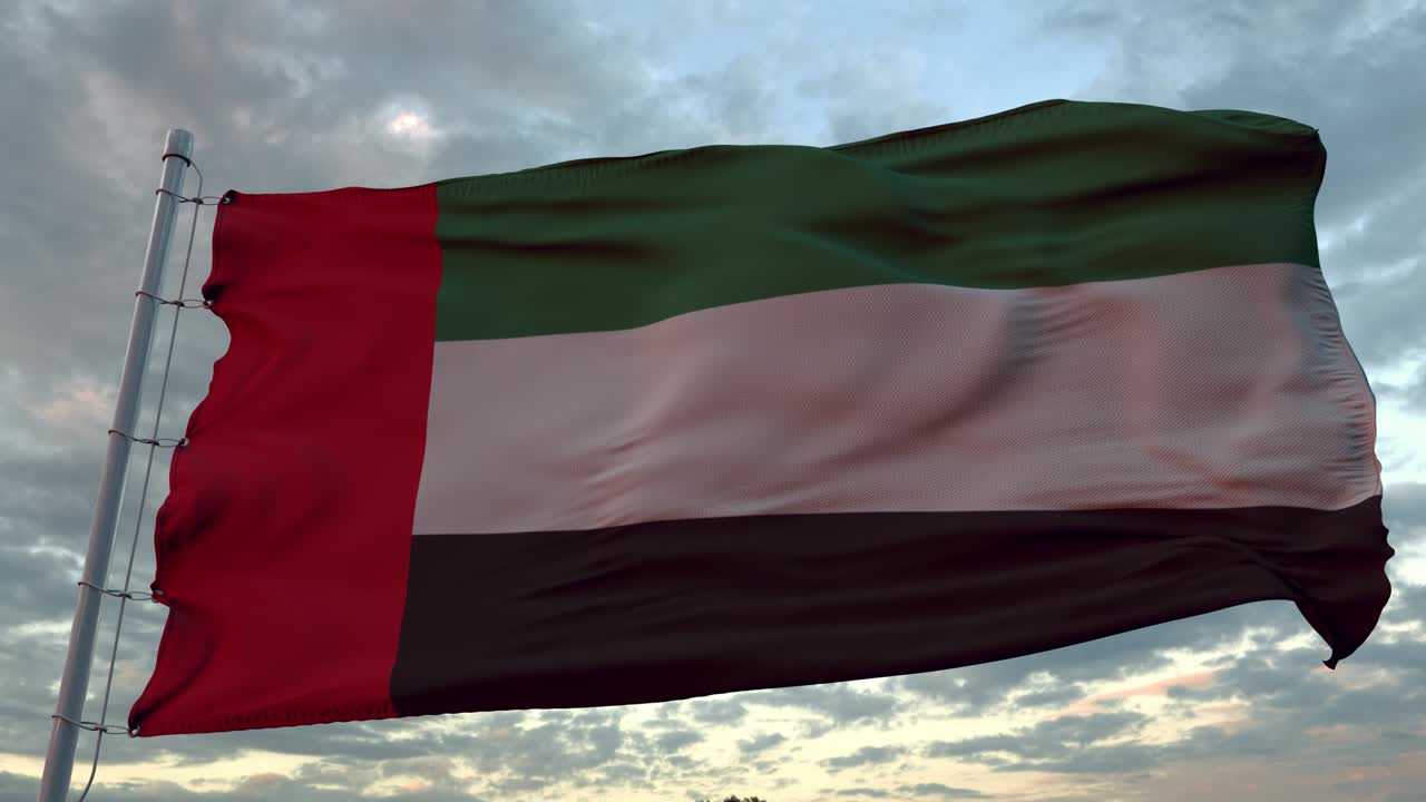 bandera de los emiratos árabes unidos ondeando en el viento contra el cielo profundo hermoso al atardecer