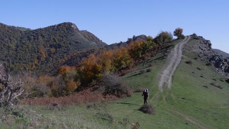 Young-man-hikes-Talysh-Mountain-trail-in-autumn-colours,-Azerbaijan