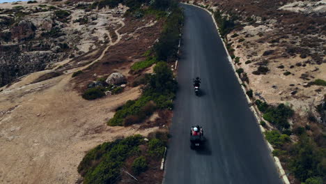 Adventurous-People-Carefree-Quad-Biking-Along-Stunning-Coastal-Road-Gozo,-Malta