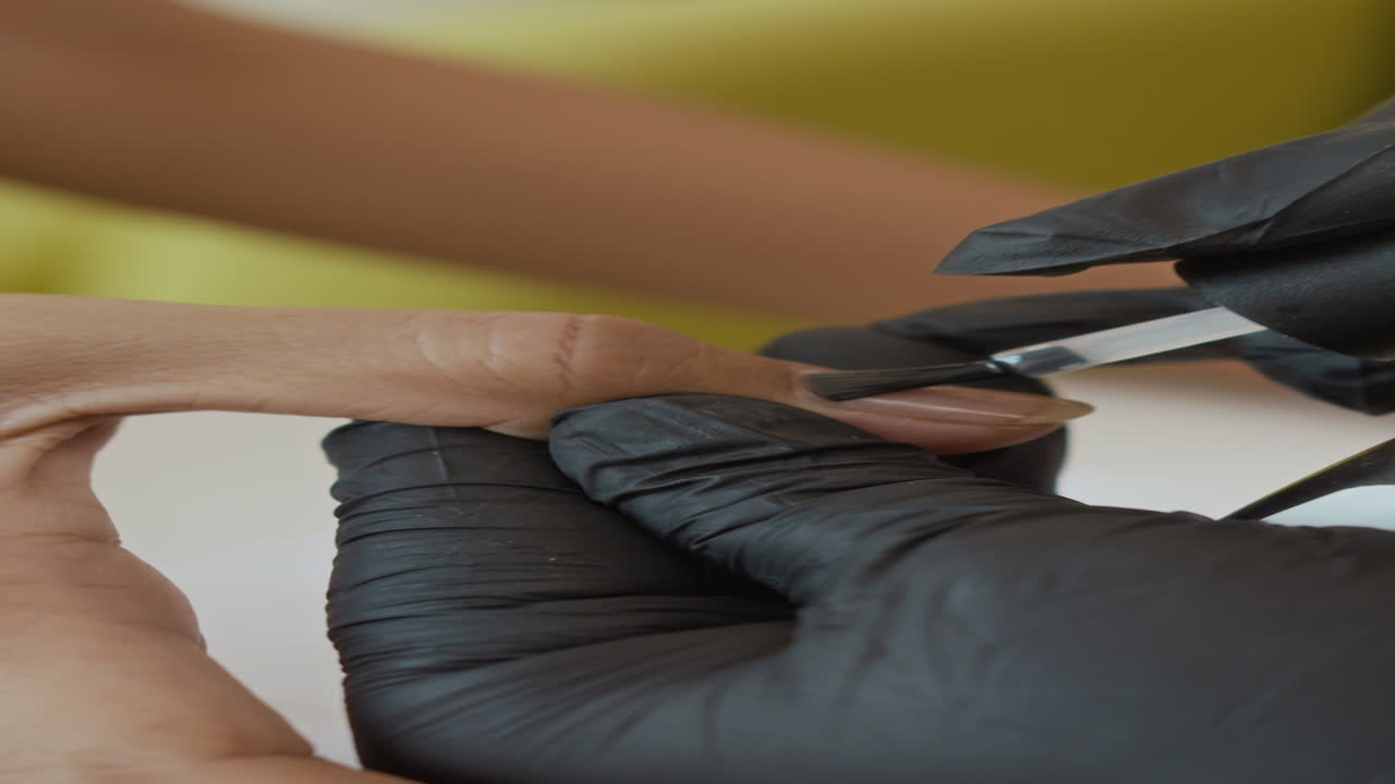 Expert Covering Nails of Woman with Gel Polish